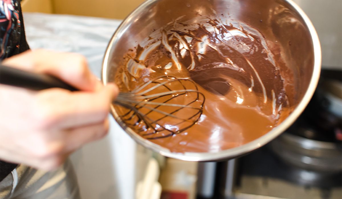 Language student creating chocolate in a bowl
