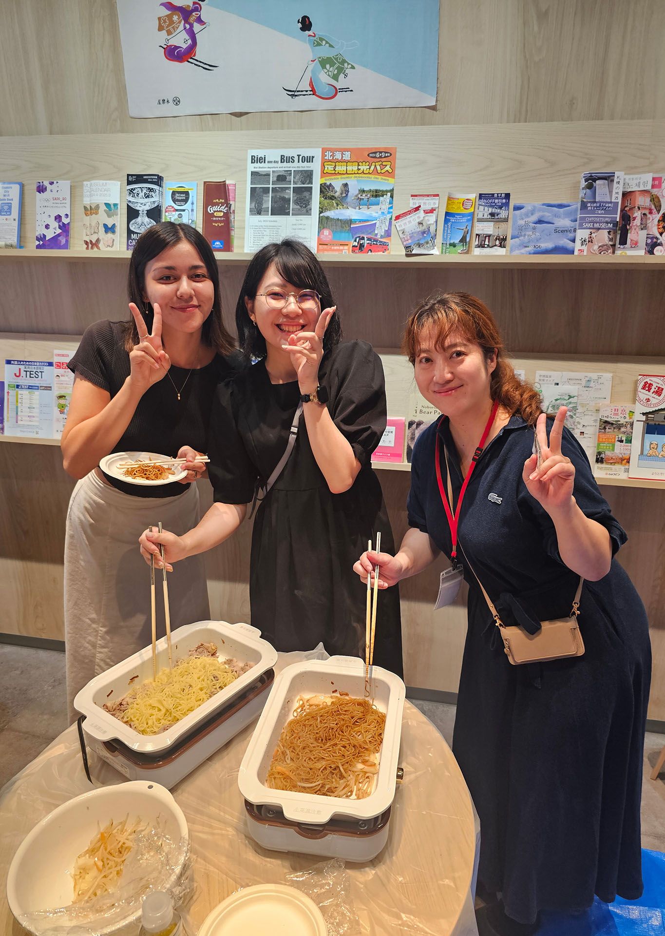 Five language students sit at a table participating on japanese cooking workshop