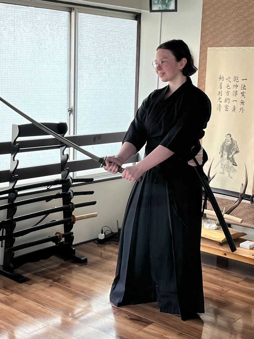 Language student practices with a Katakana Sword in traditional clothing