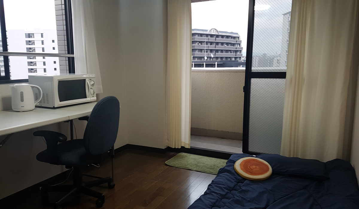 Desk and balcony of private apartment in Fukuoka