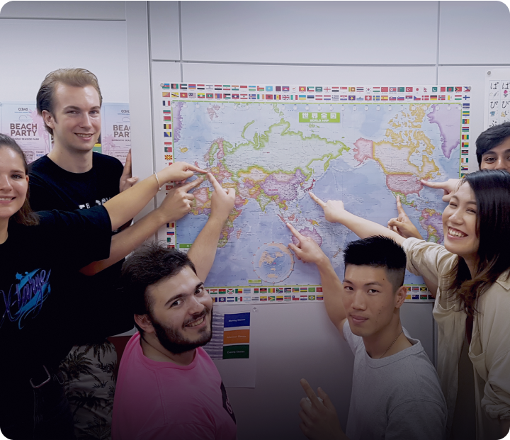 Language students pointing to their home location on a map