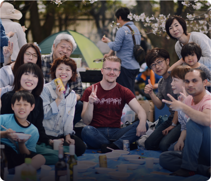 Language students enjoying a sunny picnic outside