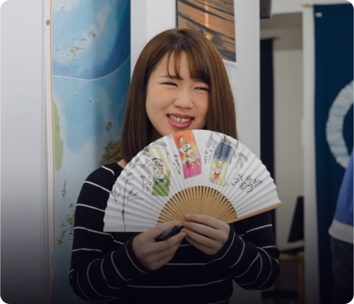 Language teacher holding a traditional sensu