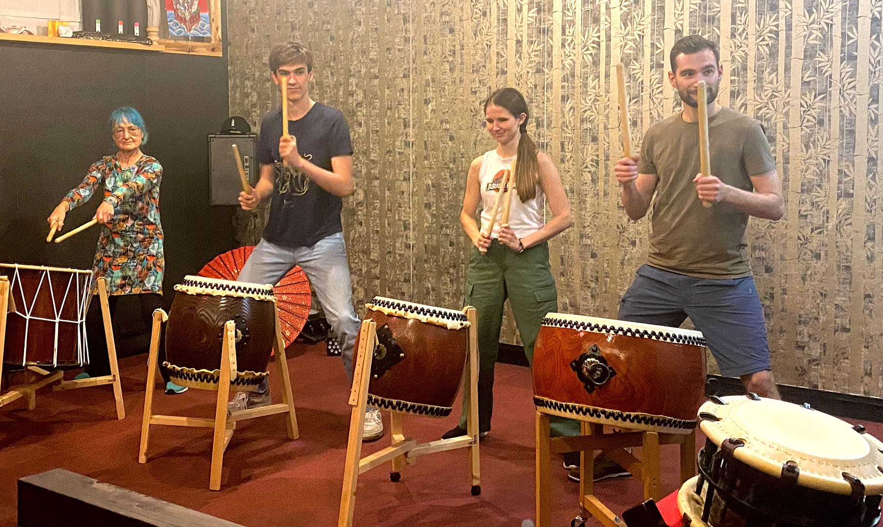 Language students playing on traditional taiko drums